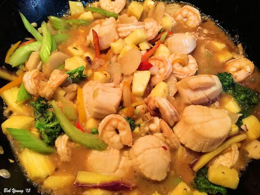 Scallops, shrimp, celery, broccoli and pineapple in a wonderful stir fry. Here it is cooking.