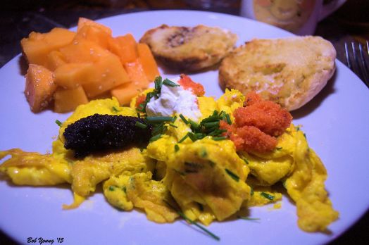 Scrambled Eggs with Chives, Lumpfish Caviar, Sour Cream and Herring Red Row. Fresh Idaho Cantaloupe and Toasted English Muffin